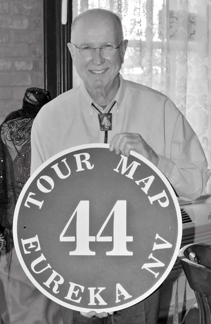 Man holding Eureka Nevada sign